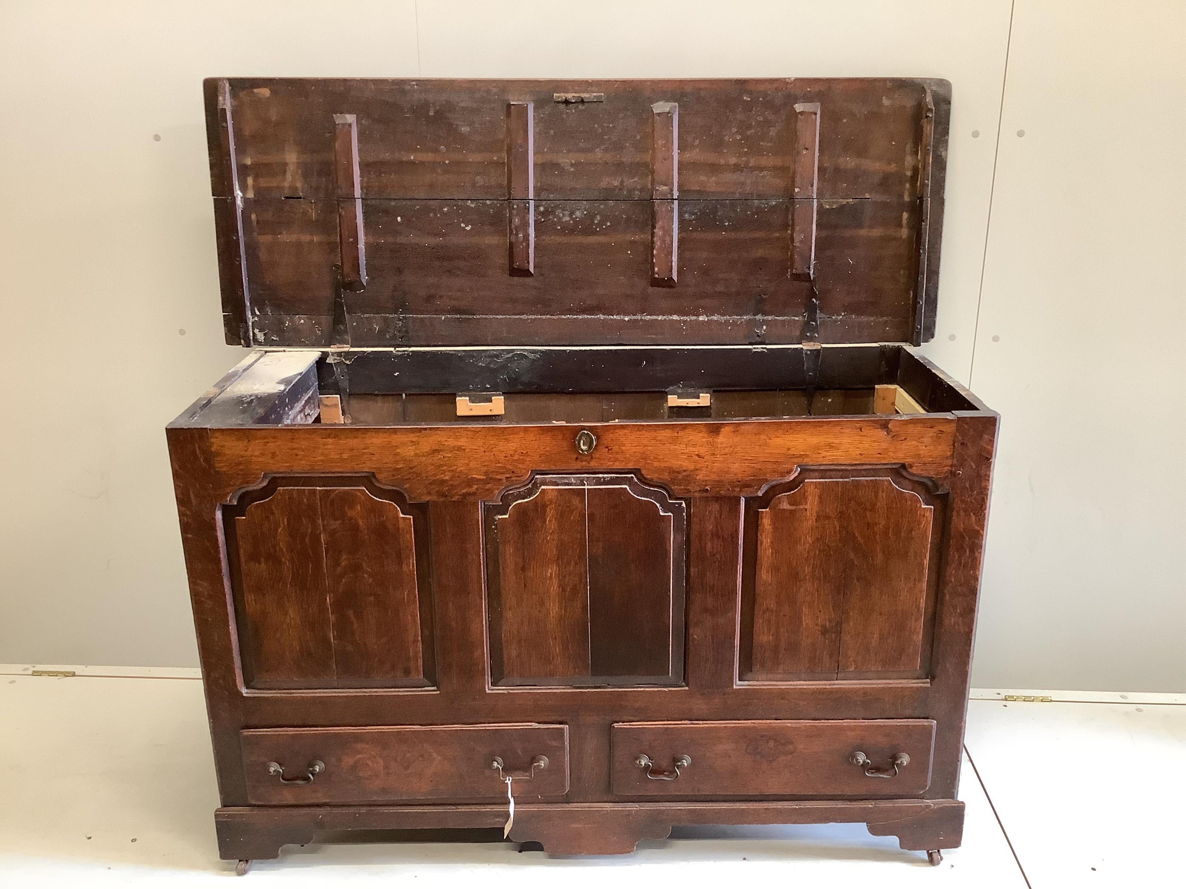 An 18th century panelled oak mule chest, adapted, width 152cm, depth 54cm, height 92cm